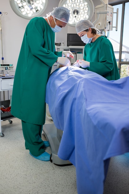 Surgeons operating patient