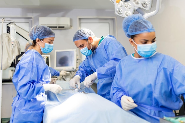 Surgeons performing surgery doctors are monitoring patient in\
operating room they are in hospital