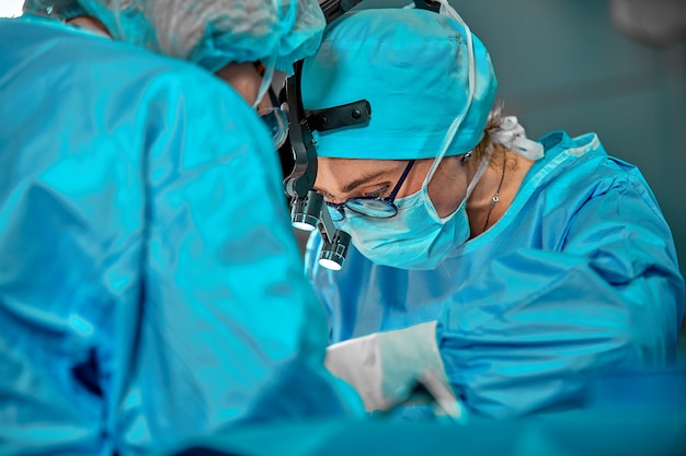 Photo surgeons team in the operating room, portraits close-up. modern operating, plastic surgery. beauty industry