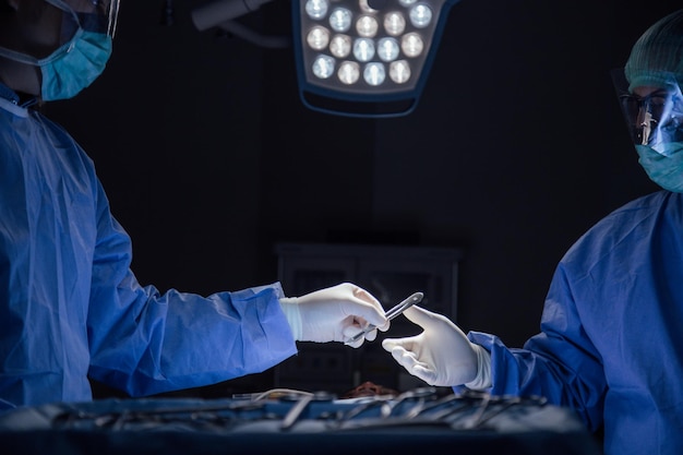 Surgeons working in illuminated operating room