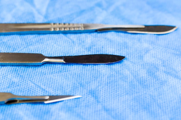 Surgery blade on the sterile table scalpel close-up