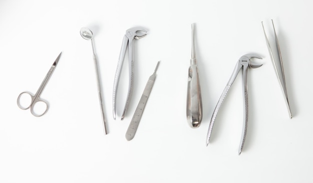 Surgical dental metal instruments on a white background Top view Flat lay