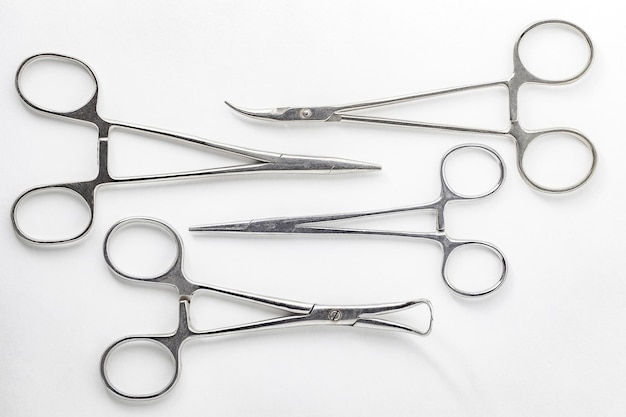 Surgical hemostatic clamps made of stainless steel on white background