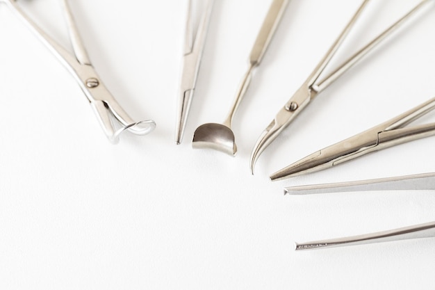 Surgical instruments metal on white background selective focus