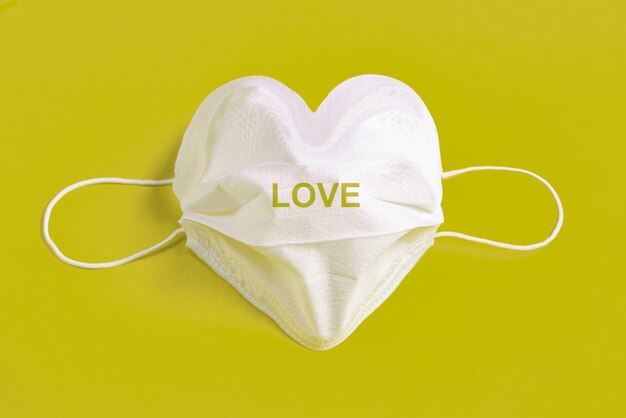 Surgical mask in the form of heart over colorful background