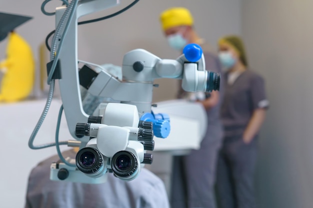 Surgical microscope in operating room with doctors ophthalmological clinic