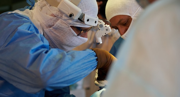 Surgical operation, view from behind the shoulder of the operating nurse