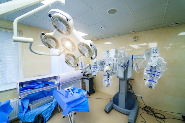 Surgical room in hospital with robotic technology equipment, machine arm surgeon in futuristic operation room. Minimal invasive surgical innovation, medical robot surgery with endoscopy