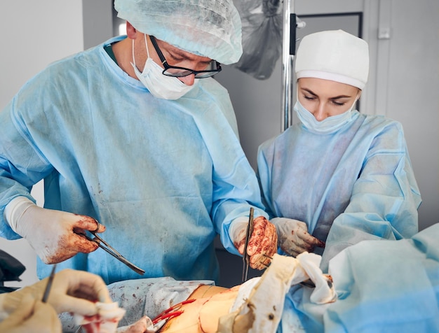 Surgical team conducting abdominoplasty surgery in operating room