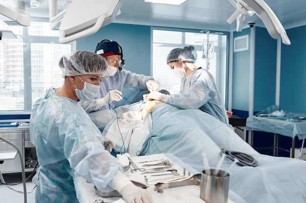 수술팀이 수술실에서 환자를 수술합니다. 숙련된 마취과 전문의가 정교한 장비를 갖추고 수술 내내 환자와 동행합니다.