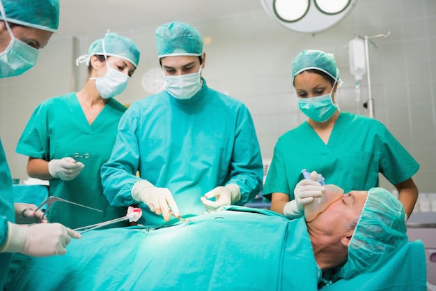 Surgical team performing on a patient belly