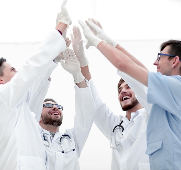 Surgical team raising their hand