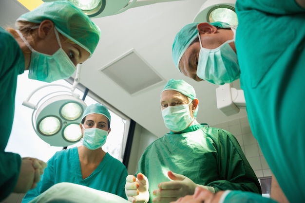 Surgical team working on a bleeding patient