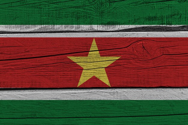 Suriname flag painted on old wood plank