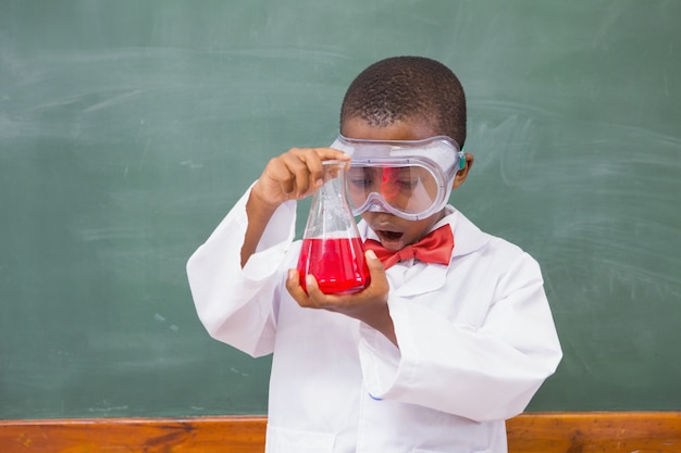 Surprise pupil looking at a red liquid 