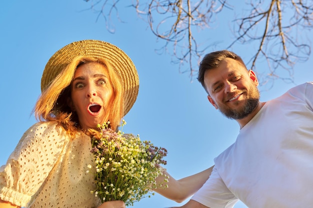 Surprised adult couple man and woman looking at camera with emotion of surprise