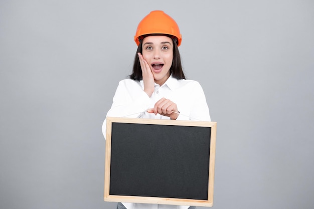 Surprised amazed wow woman construction manager woman builder\
isolated portrait with protect helmet