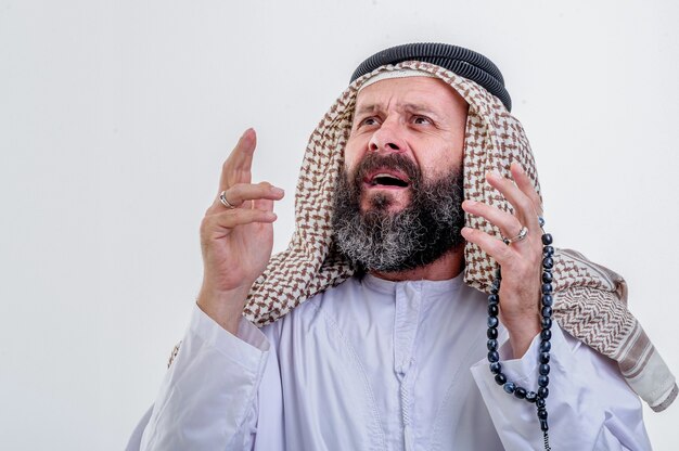 Surprised Arabic man posing on wwhite background.