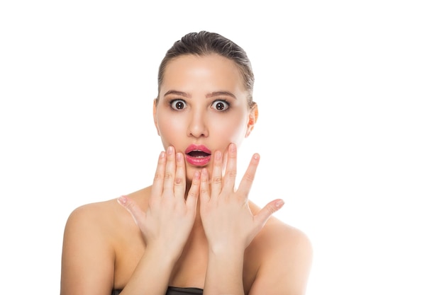 surprised beautiful woman on white background. perfect fresh skin. youth and skin care concept.