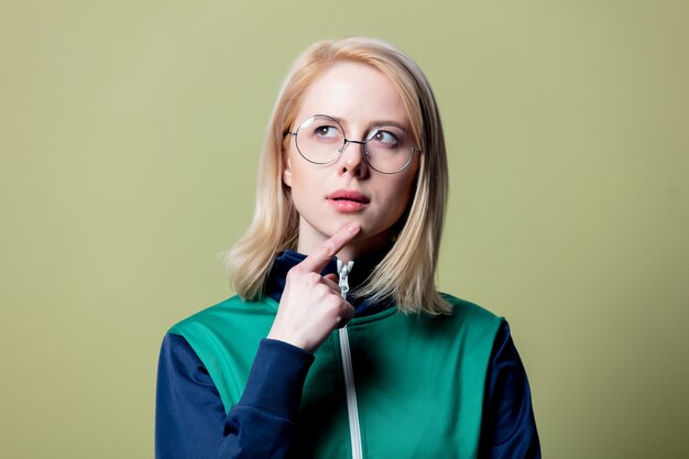 Surprised blonde woman in 80s clothes and glasses