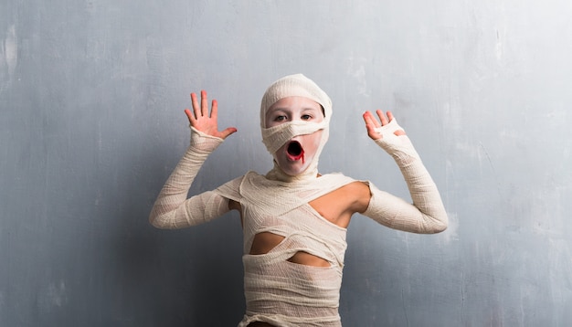 Surprised boy in mummy costume for halloween holidays