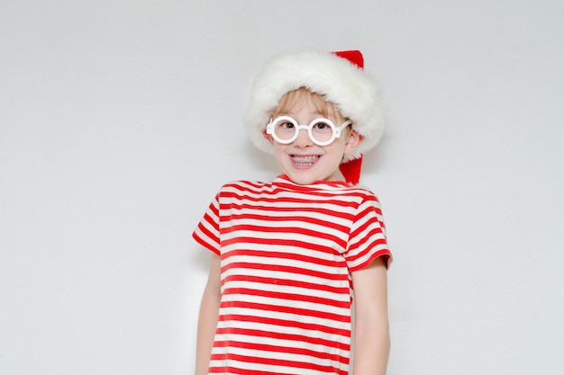 Surprised boy in a santa hat and glasses Portrait