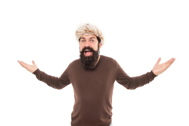 Surprised brutal hipster with beard in earflape hat isolated on white background, fashion.