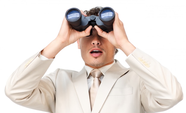 Surprised businessman looking through binoculars 