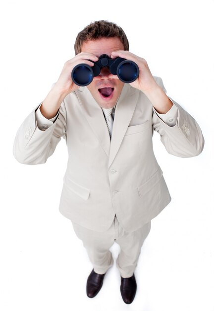 Surprised businessman looking through binoculars