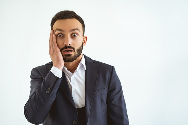 The surprised businessman standing on the white background