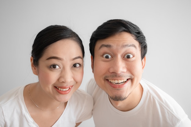 Surprised over couple funny face in white t-shirt and white background.