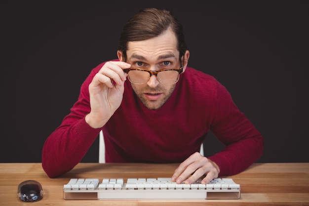 Surprised creative businessman working at desk