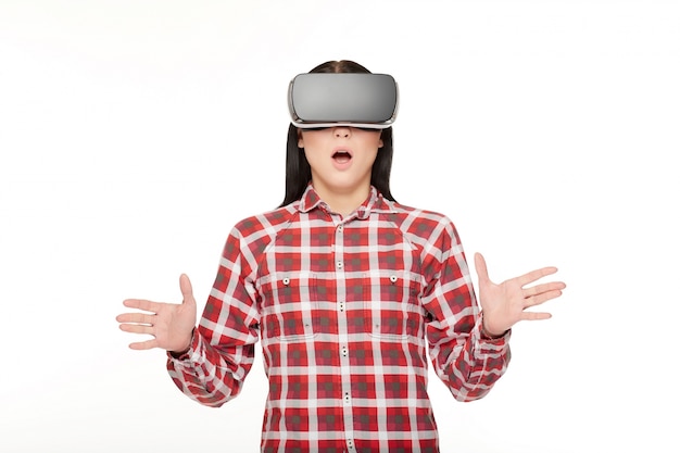 Surprised emotional woman in vr gesturing by hands.