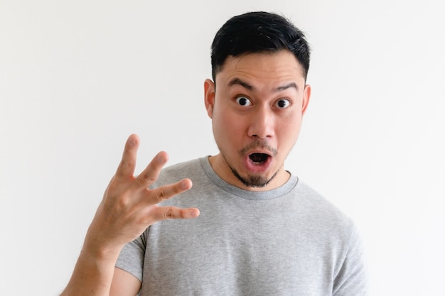 Surprised face Asian man making number hand sign on isolated white space.