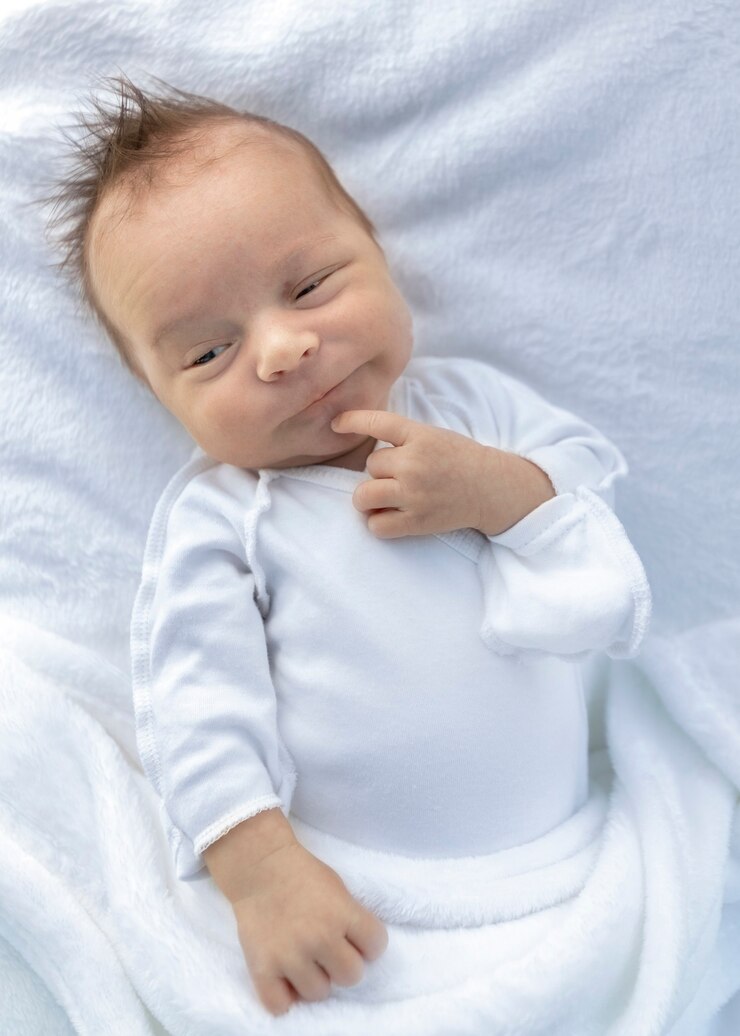 Surprised facial expression of a newborn close-up.