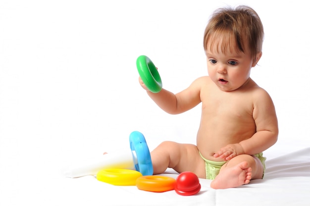 Surprised funny baby playing with toy