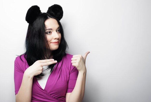 Surprised funny young woman with mouse ears studio shot