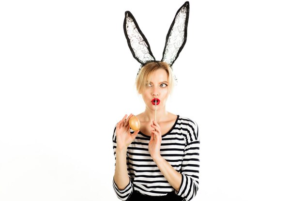 surprised girl in black bunny mask painting easter eggs rabbit girl with color egg and paint brush