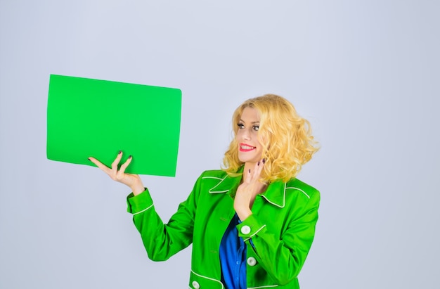 Surprised girl holds advertising board sign board copy space
for text advertising and sale