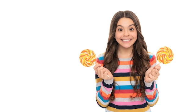 Surprised kid in sweater with lollipop candy on stick isolated on white background sweet life