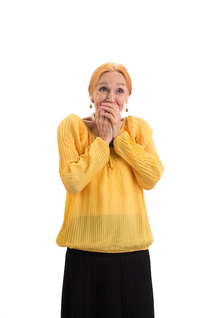 Surprised lady covering mouth amazed senior woman isolated wonders are real