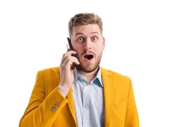 Surprised male talking on smartphone