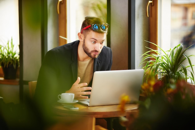 Surprised man at laptop