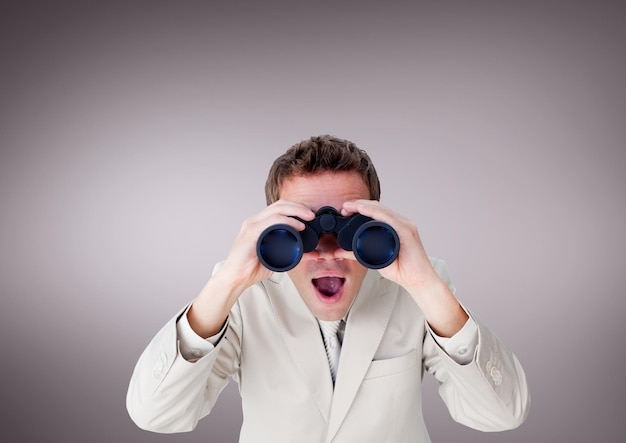 Surprised man looking through binoculars against purple background