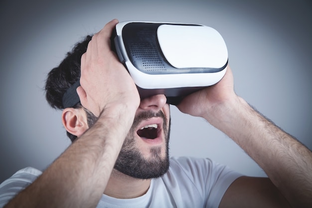 Surprised man wearing virtual reality goggles.