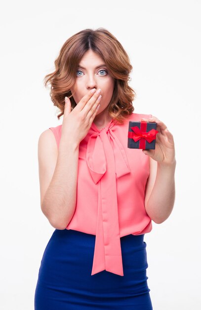 Surprised pretty woman holding gift box