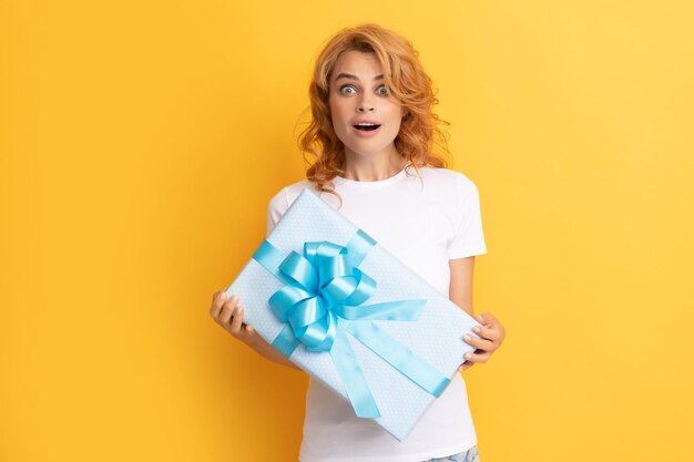 Surprised redhead girl with gift box boxing day