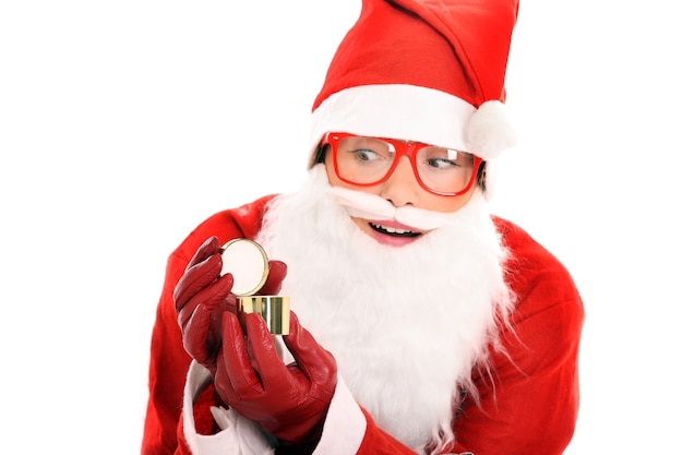 a surprised Santa opening a small golden present over white background