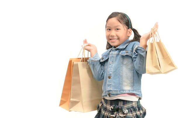 Surprised shopping girl holding shopping paper bags 