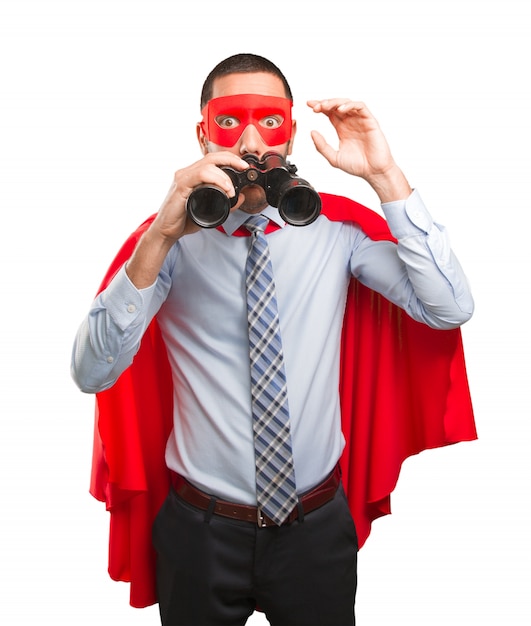 Photo surprised super businessman using a binoculars